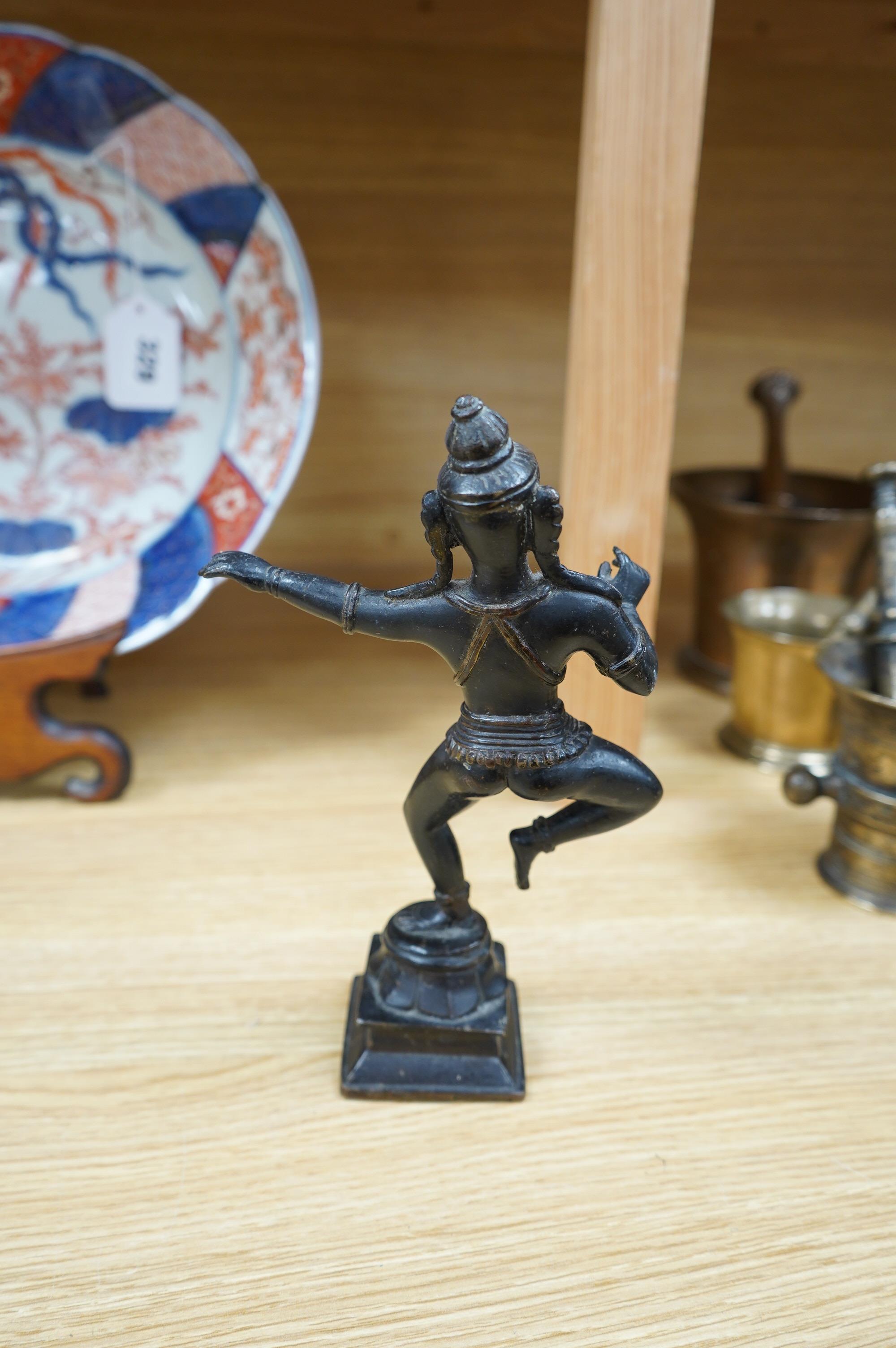 A Tibetan bronze dancing deity, 23cm high. Condition - fair